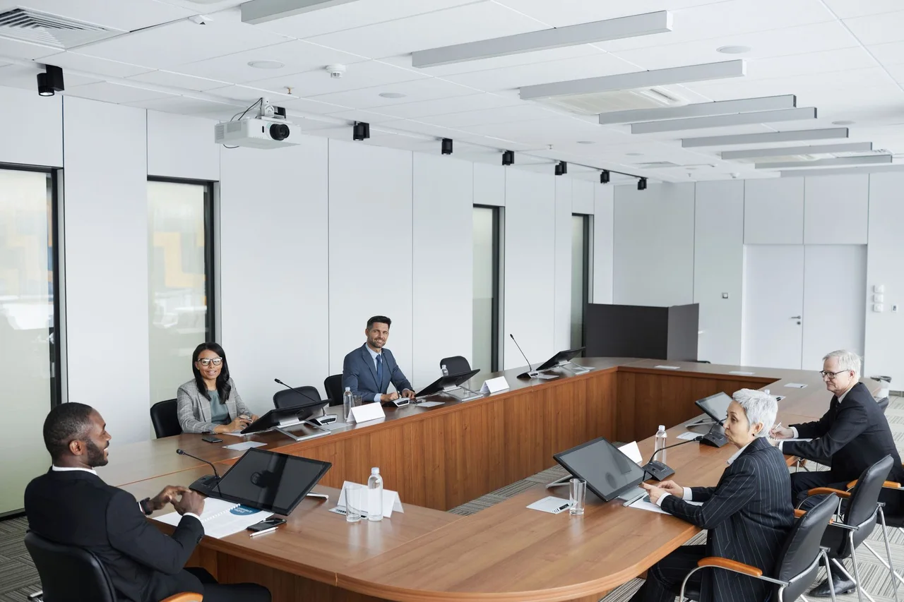 Professionals in discussion around a boardroom table