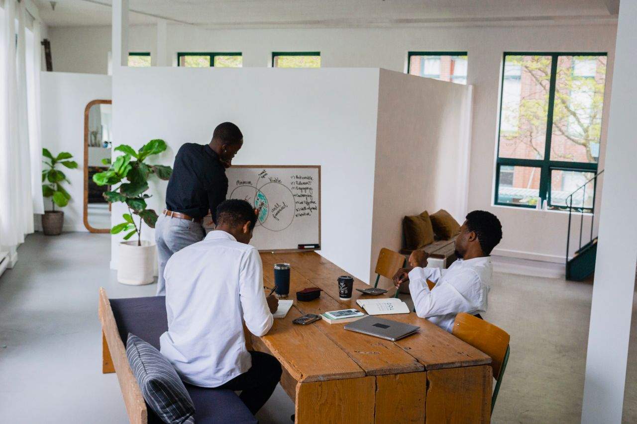 Colleagues considering a business plan together in a light-filled workspace